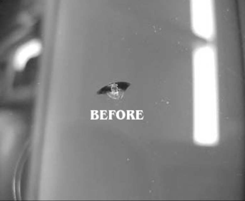 Half-moon rock chip in a windshield, before repair