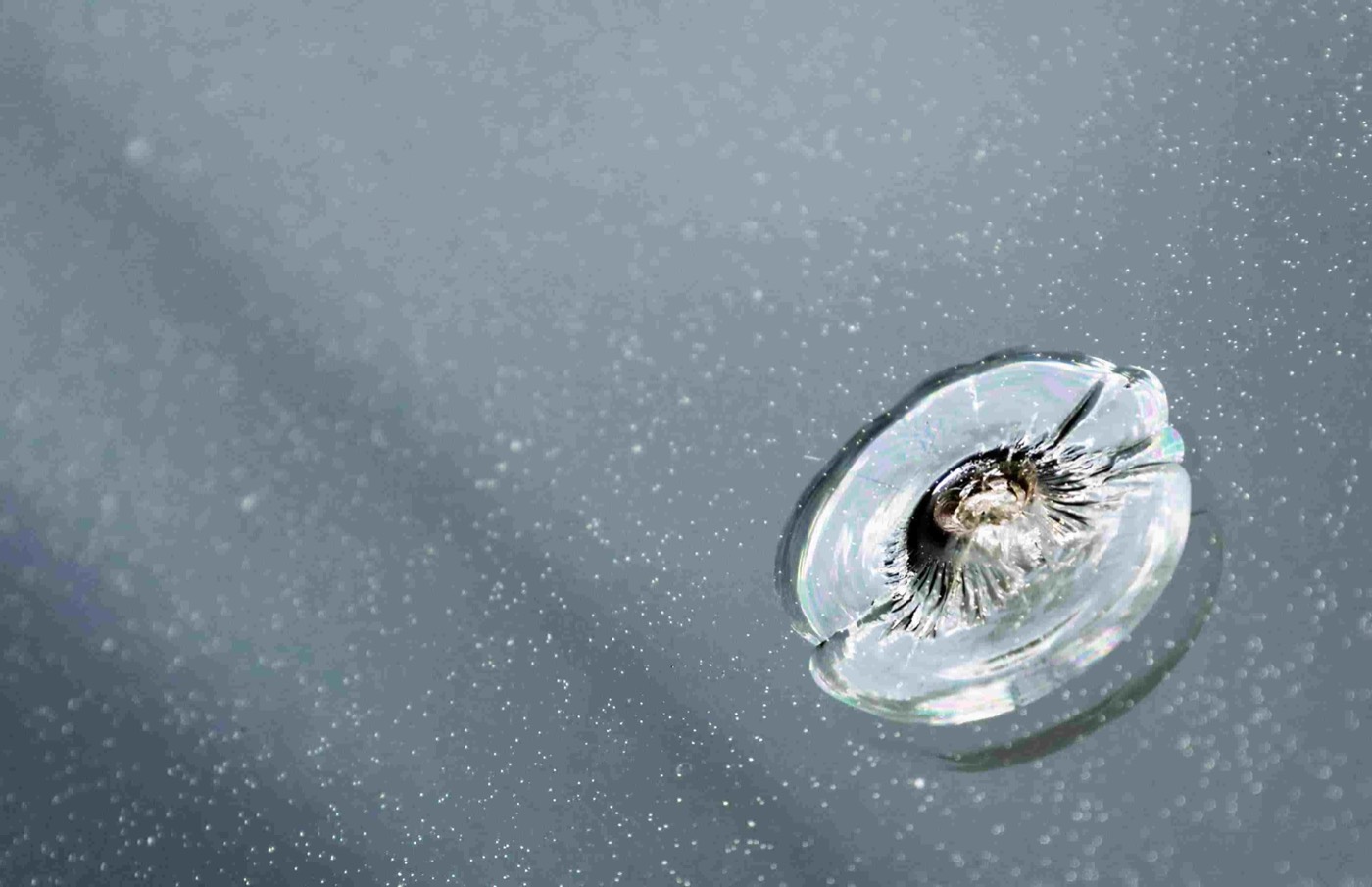 Close-up of a bullseye rock chip in a windshield